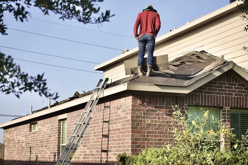 Professional roofer working on a residential roof in Martin Manor
